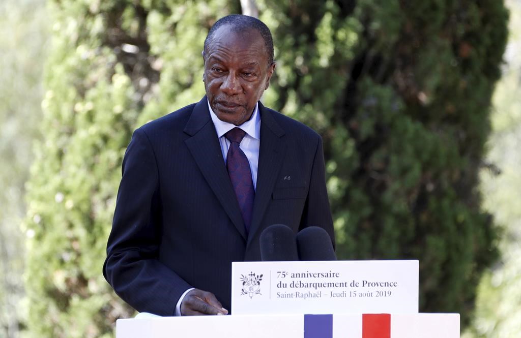 FILE - In this Thursday, Aug. 15, 2019 file photo, Guinean President Alpha Conde delivers a speech during a ceremony marking the 75th anniversary of the WWII Allied landings in Provence, in Saint-Raphael, southern France. Witnesses say heavy gunfire has erupted near the presidential palace in Guinea's capital and went on for hours. It was not immediately known whether President Alpha Conde was home at the time the shooting began. But the gunfire prompted security concerns in the West African country with a long history of coup attempts. (Eric Gaillard/Pool Photo via AP, File).