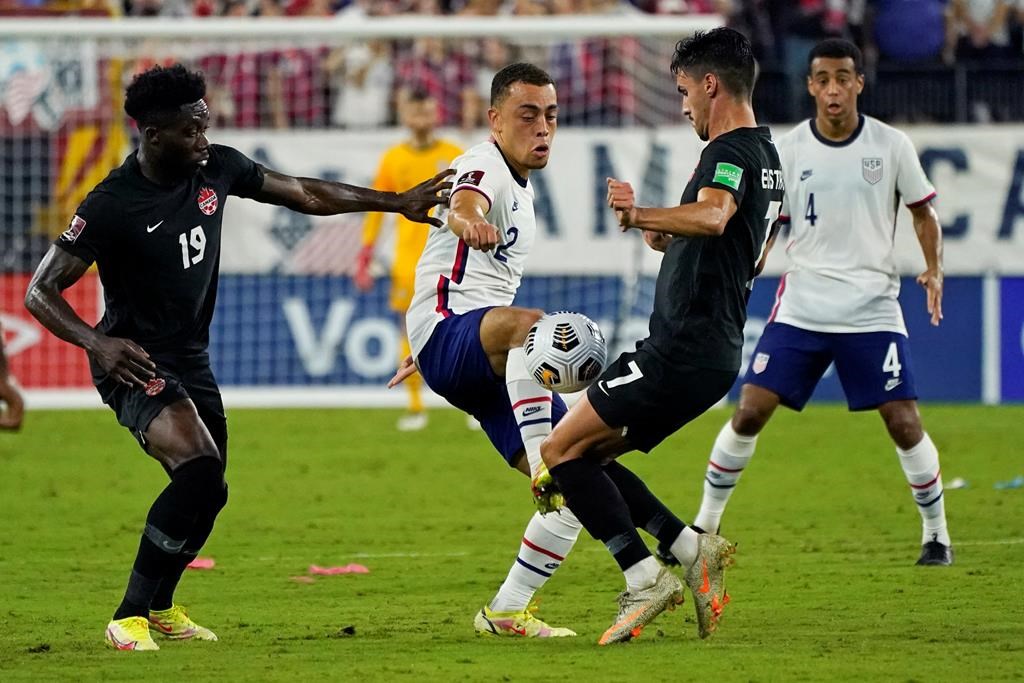 United States defender Sergino Dest (2) battles for the ball with Canada defender Alphonso Davies (19) and Canada midfielder Stephen Eustaquio (7) during the first half of a World Cup soccer qualifier in Nashville, Tenn., Sunday, Sept. 5, 2021.