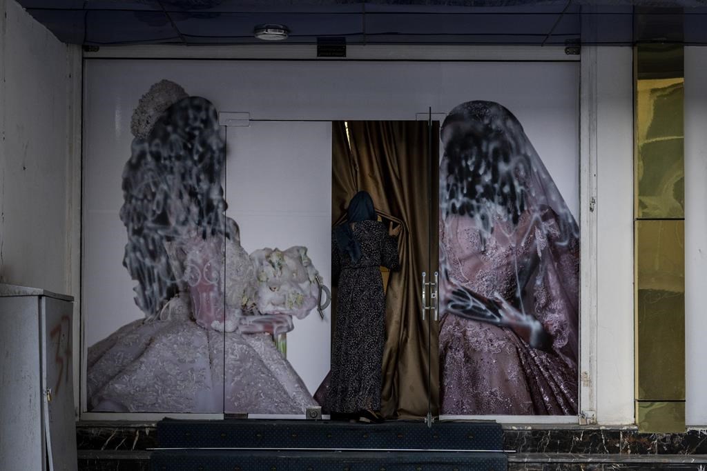 Since the Taliban gained control of Kabul, several images depicting women outside beauty salons have been removed or covered up. (AP Photo/Bernat Armangue)