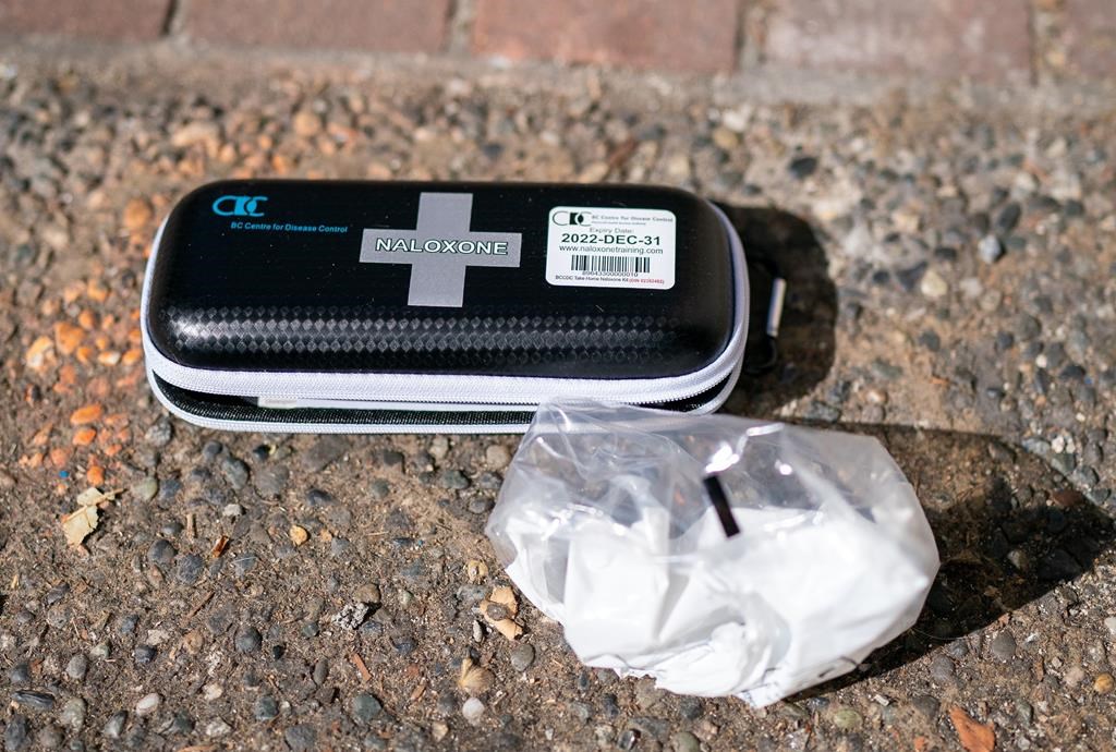 A used naloxone kit is seen on the sidewalk as paramedics from B.C. Ambulance respond to a drug overdose in downtown Vancouver, Wednesday, June 23, 2021.