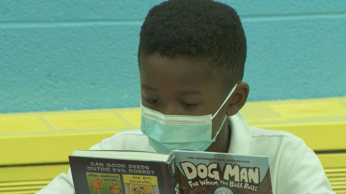 A student at Allion Elementary in LaSalle reads a book at the school library. 