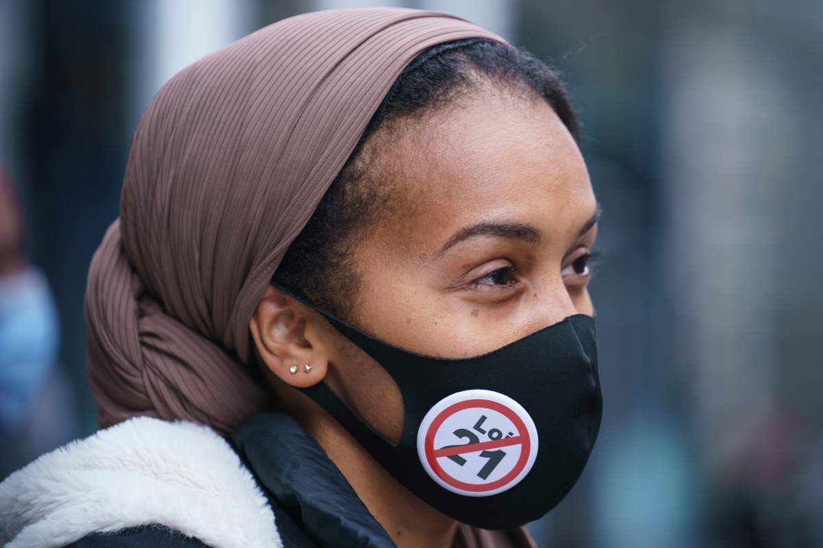 A woman takes part in a demonstration following a Superior Court ruling on Bill 21, Quebec's secularism law, in Montreal on Tuesday, April 20, 2021. THE CANADIAN PRESS/Paul Chiasson.