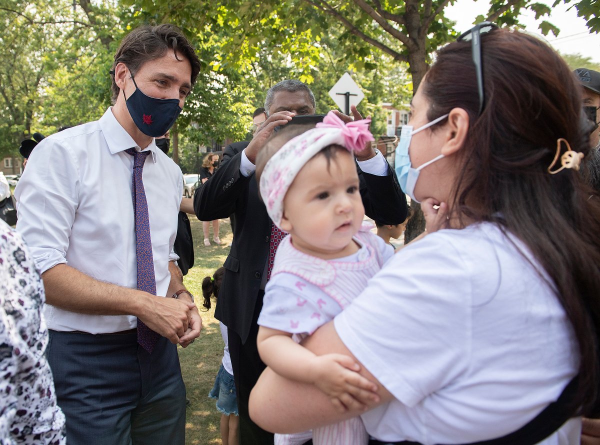 Prime Minister Justin Trudeau talks with a family following childcare funding announcement in Montreal, Thursday, August 5, 2021. 