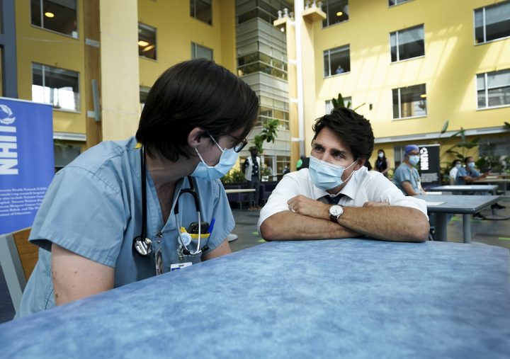 Liberal Leader Justin Trudeau, right, talks with health-care workers as he makes a campaign stop at a hospital during the Canadian federal election campaign in Toronto on Sunday, September 5, 2021. 