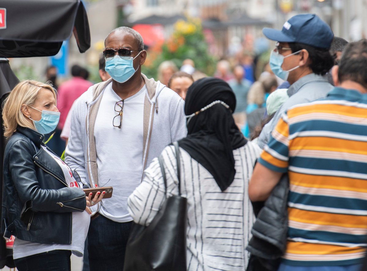 People wear face masks at they line up to enter a restaurant in Montreal, Monday, Sept. 6, 2021, as the COVID-19 pandemic continues in Canada and around the world. 