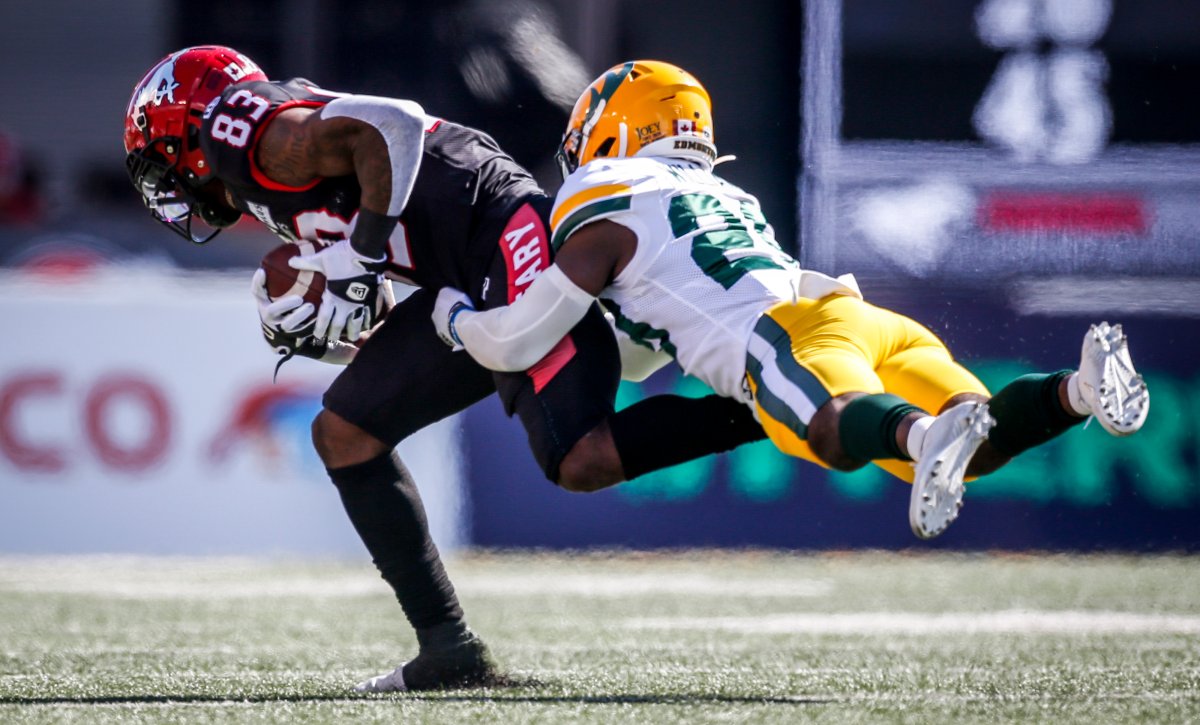 Edmonton Elks' Darius Williams, right, tackles Calgary Stampeders' Josh Huff catches a pass during first half CFL football action in Calgary, Monday, Sept. 6, 2021.