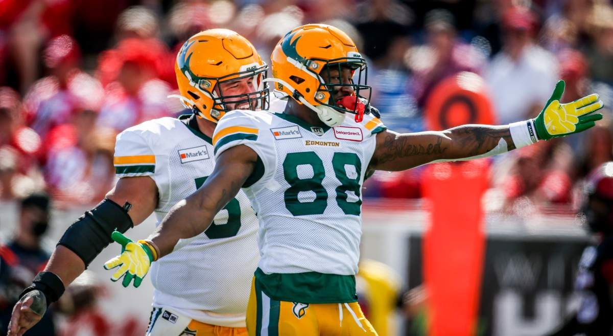 Edmonton Elks' Jalen Tolliver, right, celebrates his touchdown with teammate David Beard during first half CFL football action against the Calgary Stampeders in Calgary, Monday, Sept. 6, 2021.