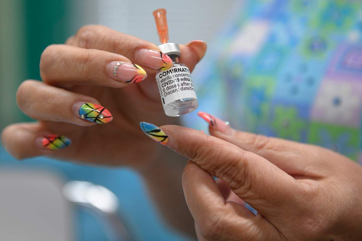 Yordanka Minekova, the chief vaccination nurse holds a container of Pfizer COVID-19 vaccine at the state hospital in Veliko Tarnovo, Bulgaria, Thursday, Sept. 2, 2021.