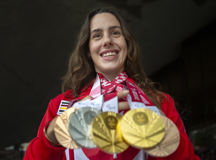 Paralympian Aurelie Rivard holds her five Paralympic swimming medals at a news conference, Wednesday, September 8, 2021 in Montreal. Rivard won two gold, a silver and two bronze medals at the 2020 Tokyo Games.