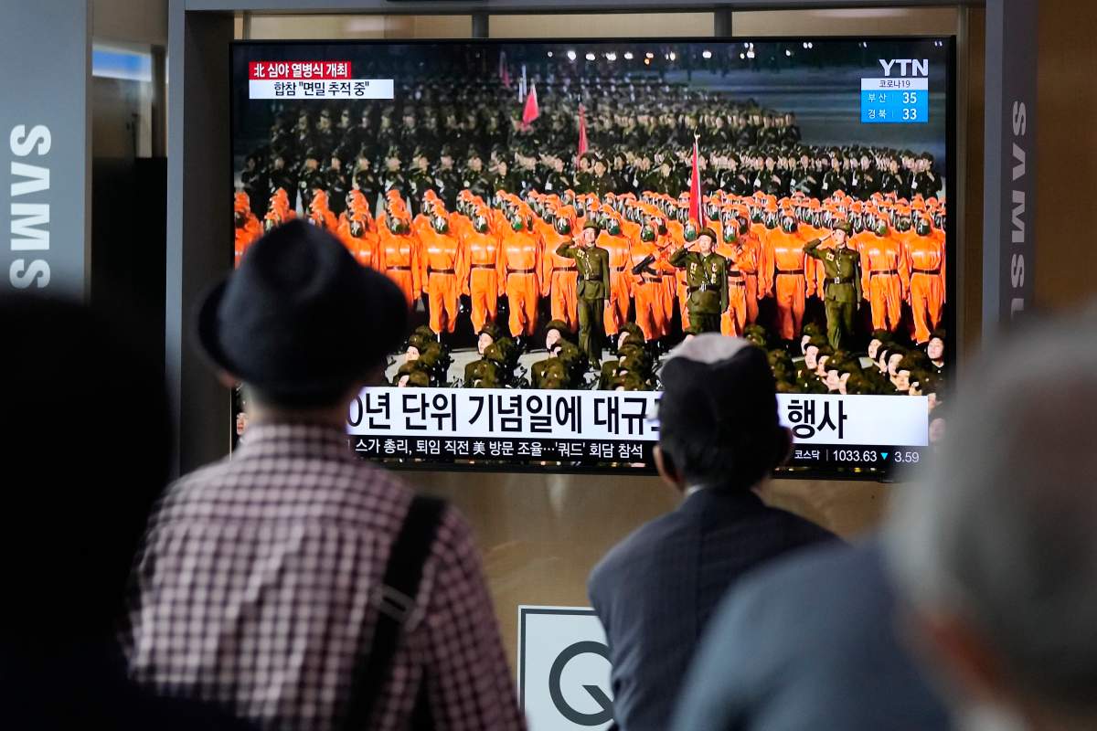 People watch a TV showing a military parade held in Pyongyang, North Korea, at Seoul Railway Station in Seoul, South Korea, Thursday, Sept. 9, 2021. North Korea paraded goose-stepping soldiers and military hardware in its capital overnight in a celebration of the nation's 73rd anniversary that was overseen by leader Kim Jong Un, state media reported Thursday. (AP Photo/Ahn Young-joon).