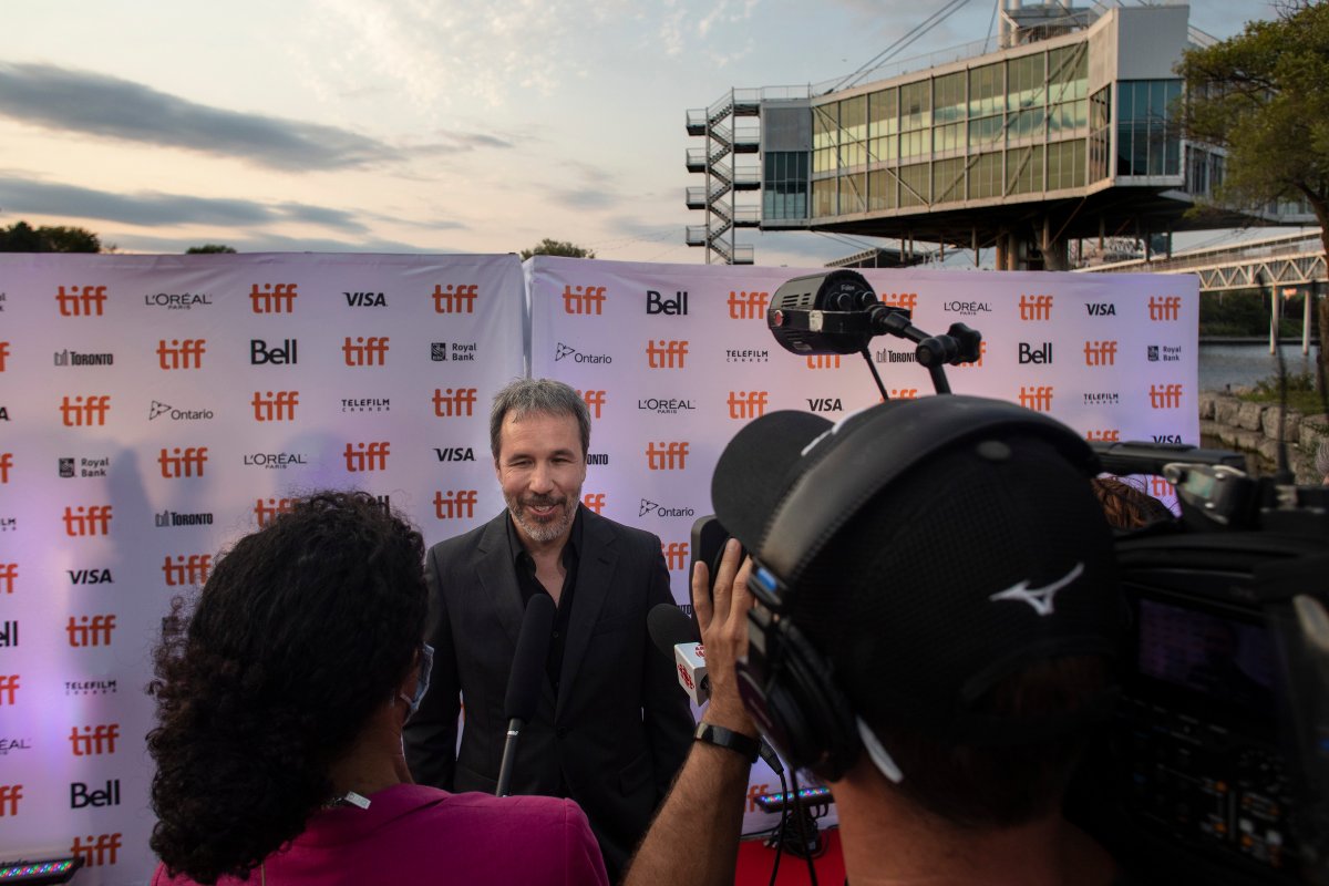 Director Denis Villeneuve speaks to a journalist as he walks the red carpet to promote the film "Dune" in Toronto during the Toronto International Film Festival, on Saturday, September 11, 2021. 