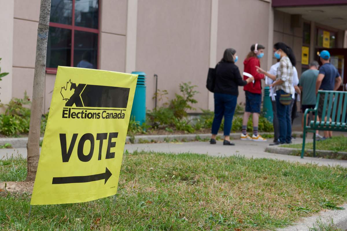 Voters line up outside an Elections Canada polling station. 