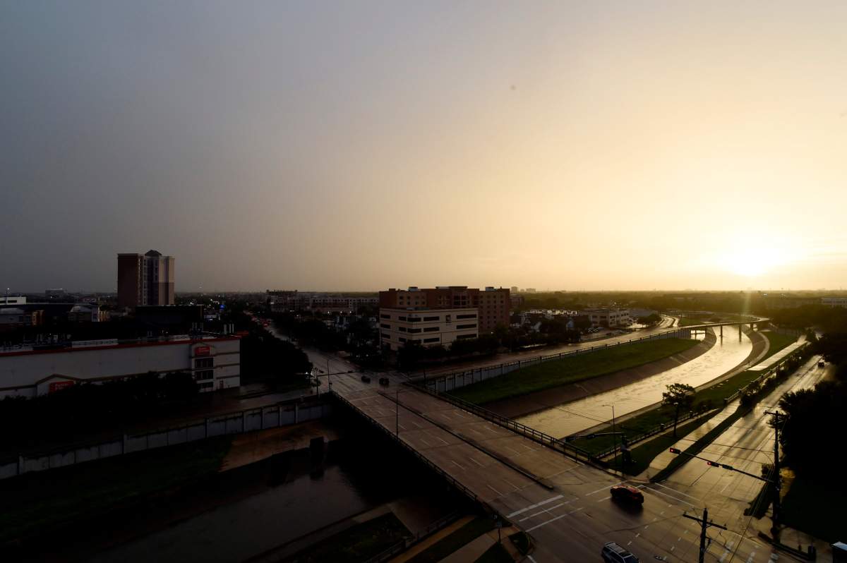 A typically busy stretch of Main St. near the Texas Medical Center is nearly empty as residents hunker down to await the winds and rain of Tropical Storm Nicholas, Monday, Sept. 13, 2021, in Houston, Texas. (AP Photo/Meg Kinnard).