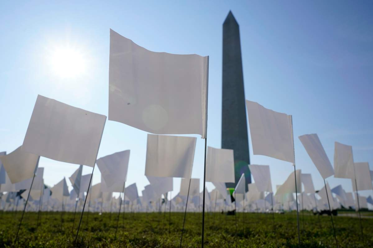 White flags stand near the Washington Monument on the National Mall in Washington, Wednesday, Sept. 15, 2021. The flags, which will number more than 630,000 when completed, are part of artist Suzanne Brennan Firstenberg’s temporary art installation, “In America: Remember,” in remembrance of Americans who have died of COVID-19. (AP Photo/Patrick Semansky)