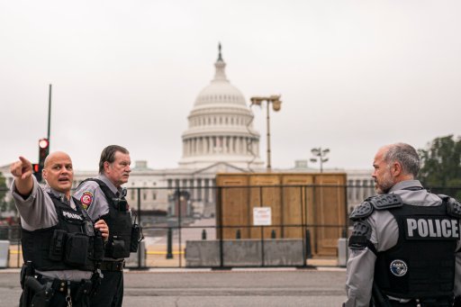Police stand outside a security fence ahead of a rally near the U.S. Capitol in Washington, Saturday, Sept. 18, 2021. (AP Photo/Nathan Howard)