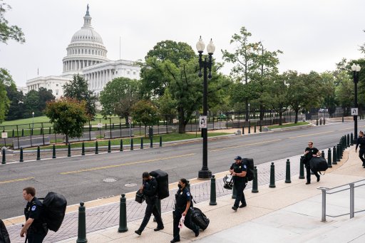 Police stage at a security fence ahead of a rally near the U.S. Capitol in Washington, Saturday, Sept. 18, 2021. (AP Photo/Nathan Howard)