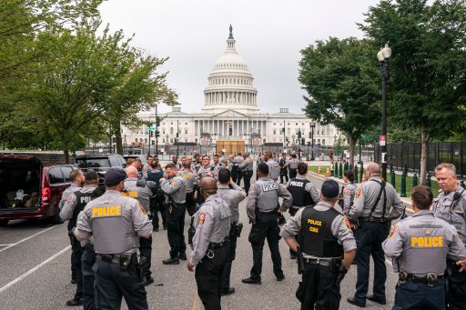 Police stage at a security fence ahead of a rally near the U.S. Capitol in Washington, Saturday, Sept. 18, 2021. (AP Photo/Nathan Howard)