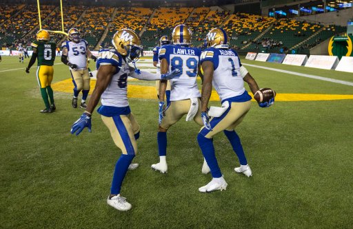 Winnipeg Blue Bombers quarterback Zach Collaros (8), Kenny Lawler (89) and Darvin Adams (1) celebrate a touchdown against the Edmonton Elks during first half CFL action in Edmonton, Alta., on Saturday, September 18, 2021.