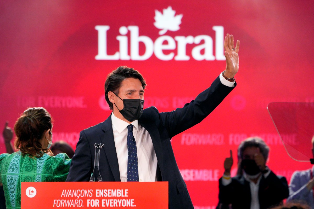 Prime Minister Justin Trudeau greets supporters prior to his victory speech at Party campaign headquarters in Montreal, early Tuesday, Sept. 21, 2021. 