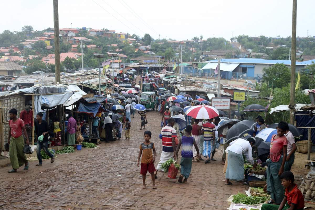 FILE - In this June 2, 2020, file photo, people shop for vegetables at the Kutupalong Rohingya refugee camp in Cox's Bazar, Bangladesh. Bangladeshi police said a key refugee leader, Mohibullah, was shot to death in the Kutupalong camp by unknown gunmen late Wednesday, Sept. 29, 2021. The 50-year-old former teacher was among 700,000 Rohingya who fled into Bangladesh after a military crackdown against the ethnic group in Myanmar in 2017. (AP Photo/Shafiqur Rahman, File).
