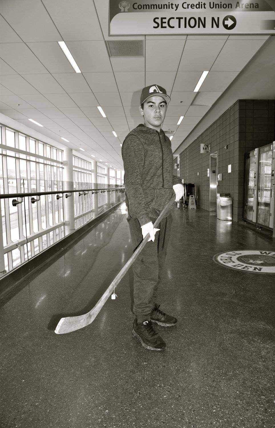 Cheryl Maloney’s son Chase, poses with a 1917 stick, handmade by his great, great grandfather, Alexander Cope.