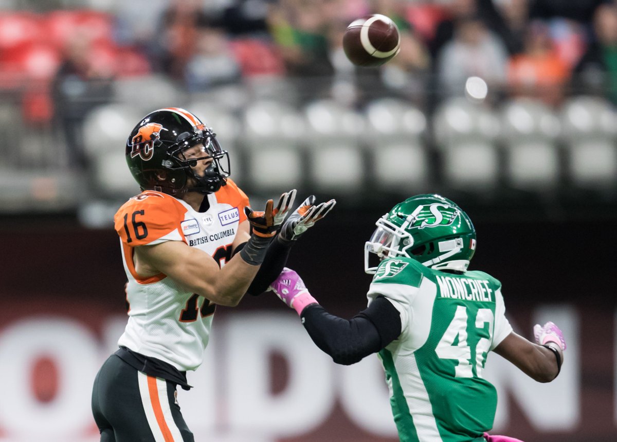 B.C. Lions' Bryan Burnham (16) makes a reception as Saskatchewan Roughriders' Derrick Moncrief (42) defends during the first half of a CFL football game in Vancouver, on Friday October 18, 2019. 