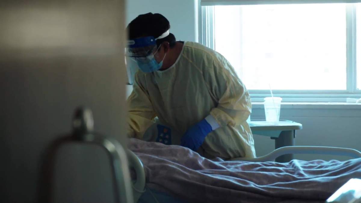 File: A health-care worker checks on a patient in the ICU at the Royal Alexandra Hospital in Edmonton, Alta. in September 2021.

