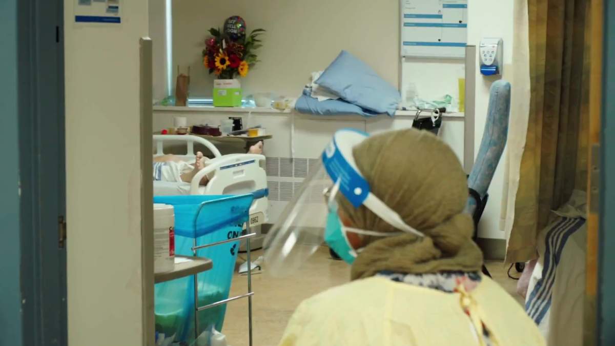 A patient and worker in the ICU at the Royal Alexandra Hospital in Edmonton, Alta. in September 2021.
