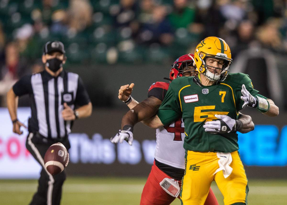 Calgary Stampeders' Shawn Lemon (40) tackles Edmonton Elks quarterback Trevor Harris (7) during second half CFL action in Edmonton, Alta., on Saturday, September 11, 2021.