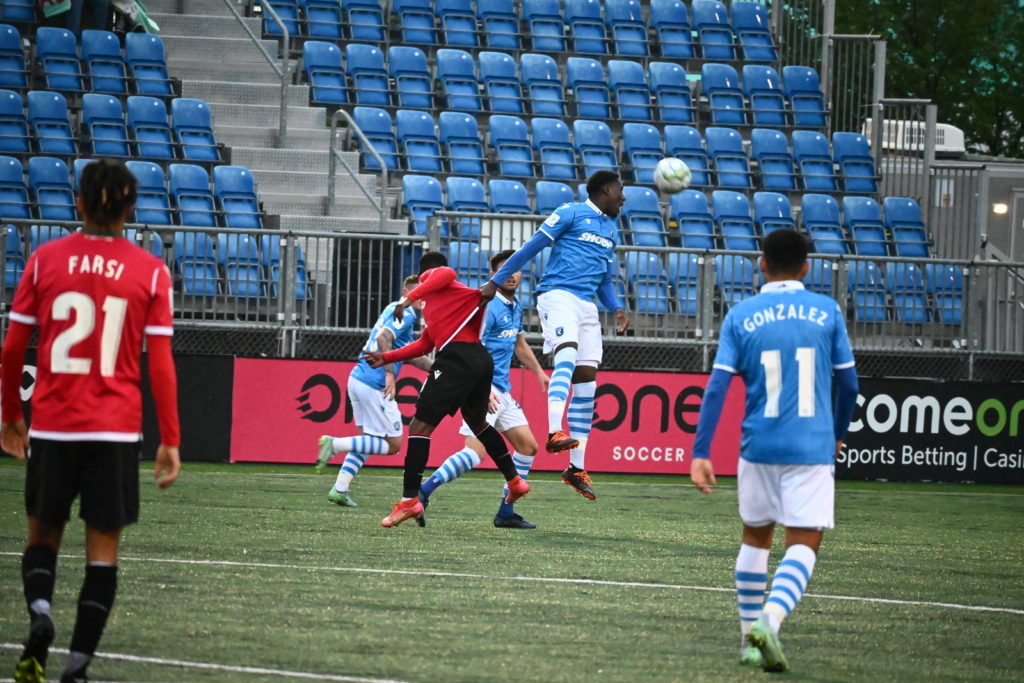 FC Edmonton and Cavalry players battle for a ball in the air in Edmonton, Alta. on Wednesday, Sept. 1, 2021. Edmonton's professional soccer team will not play next year following a decision from the CPL.
