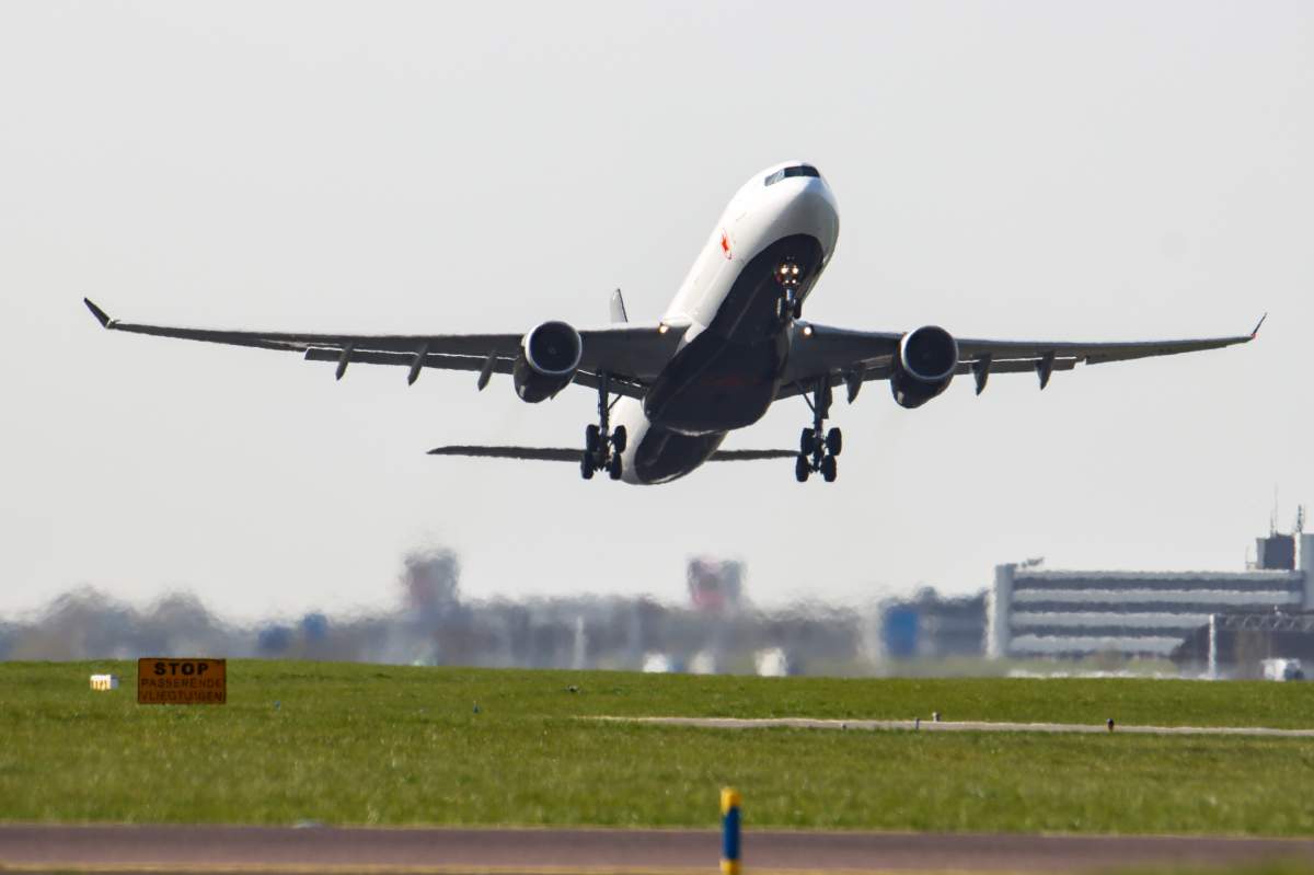 Air Canada Airbus A330-300 aircraft configured in March 2021 in cargo due to Covid019 as seen departing in the blue sky from the Dutch capital, AMS Schiphol International Airport.