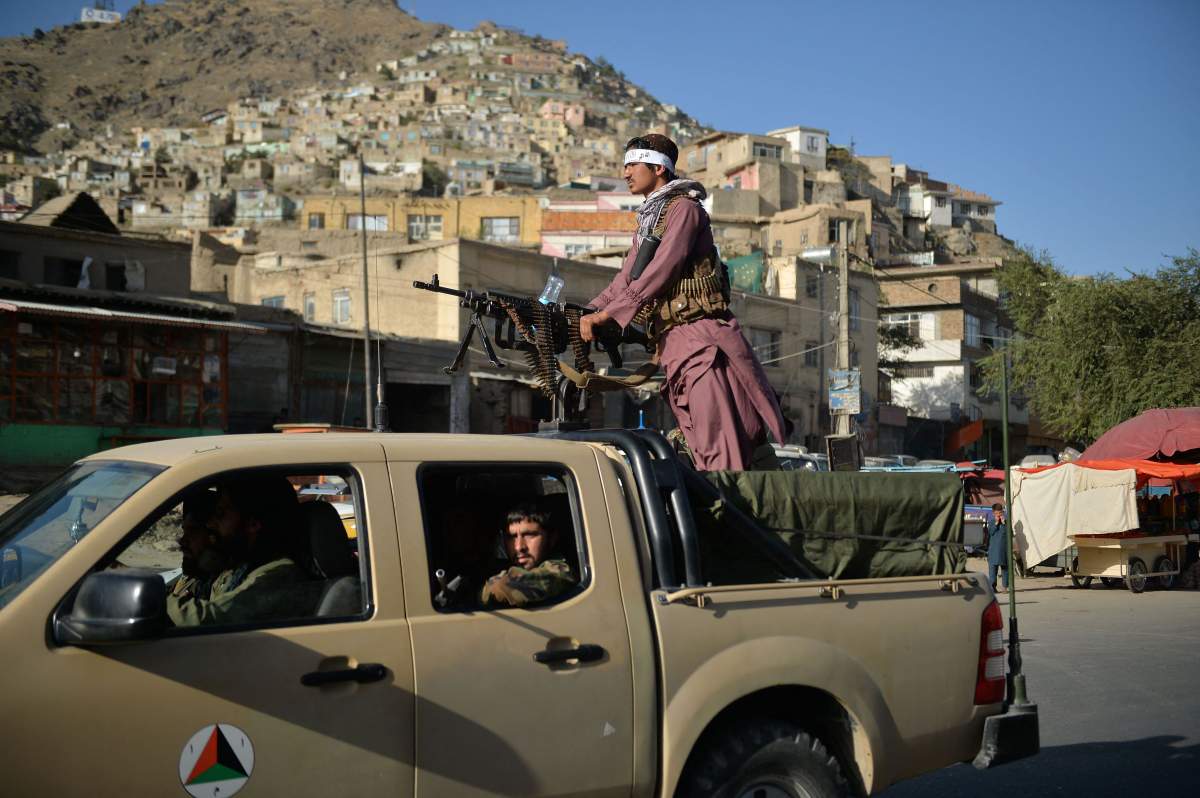 Taliban fighters patrol along a street in Kabul on September 13, 2021.