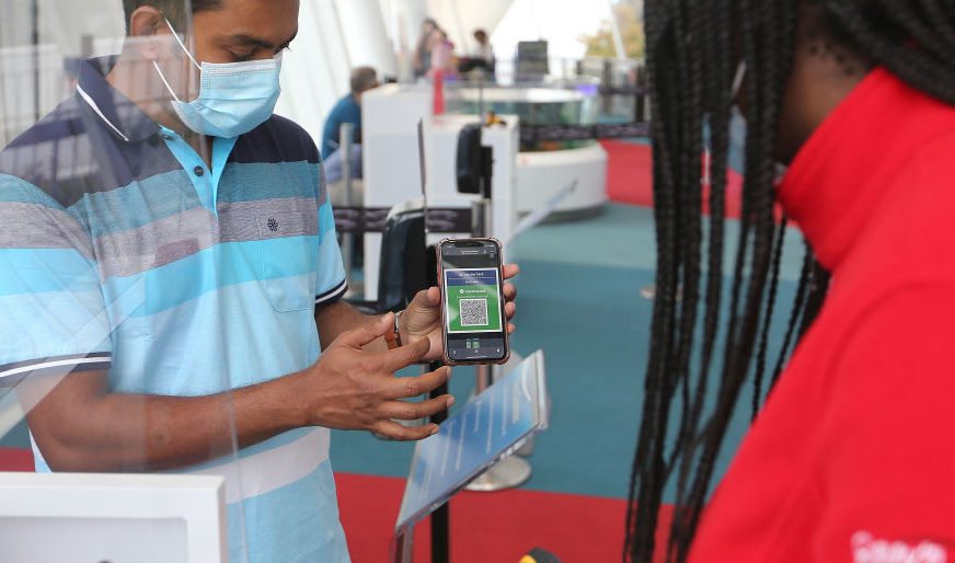 FILE - Staff at Ripleys Aquarium check guests proof of vaccinations in Toronto, September 22, 2021. The province's vaccine certificate system took effect Wednesday.