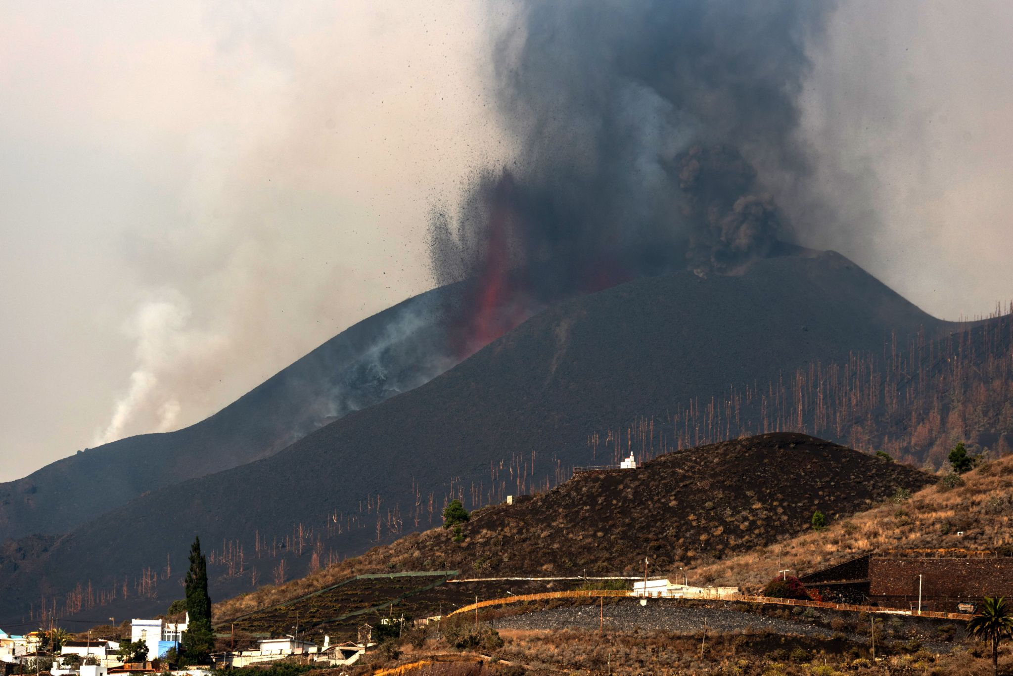 The Cumbre Vieja volcano spews lava, ash and smoke as seen from Los Llanos de Aridane on the Canary island of La Palma in Sept. 26, 2021.