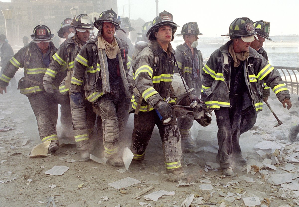 FDNY firefighters carry fellow firefighter, Al Fuentes, who was injured in the collapse of the World Trade Center on Sept. 11, 2001.