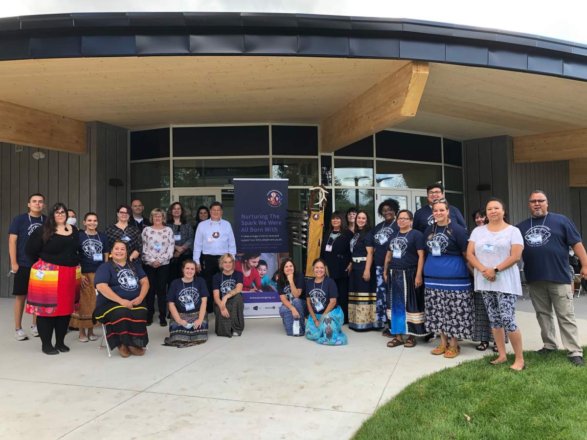 Staff gather for the soft opening of the Nshwaasnangong Child Care and Family Centre on Sept. 16, 2021.