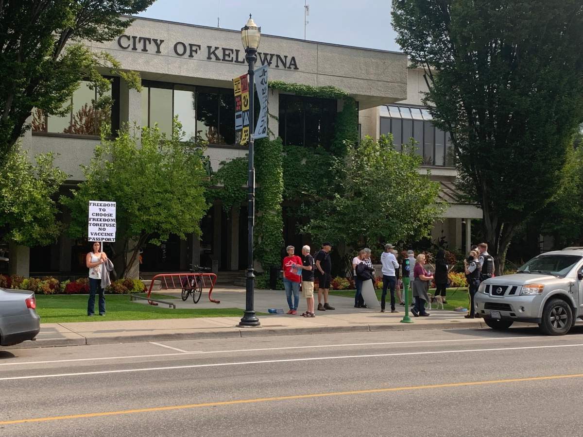 A protester holding a sign during a rally against B.C.’s vaccine passport in Kelowna on Wednesday.
