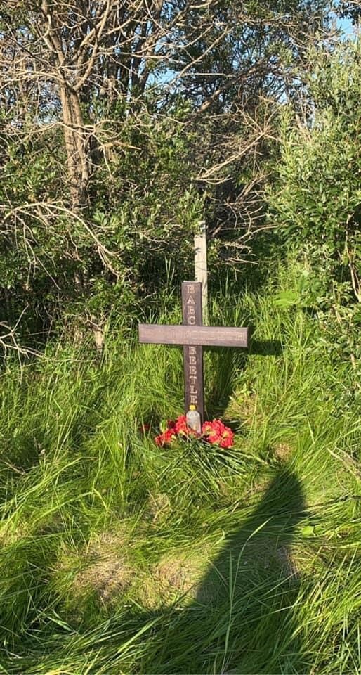 A cross is seen near the scene of an impaired driving crash that killed 43-year-old Matthew Forseth.