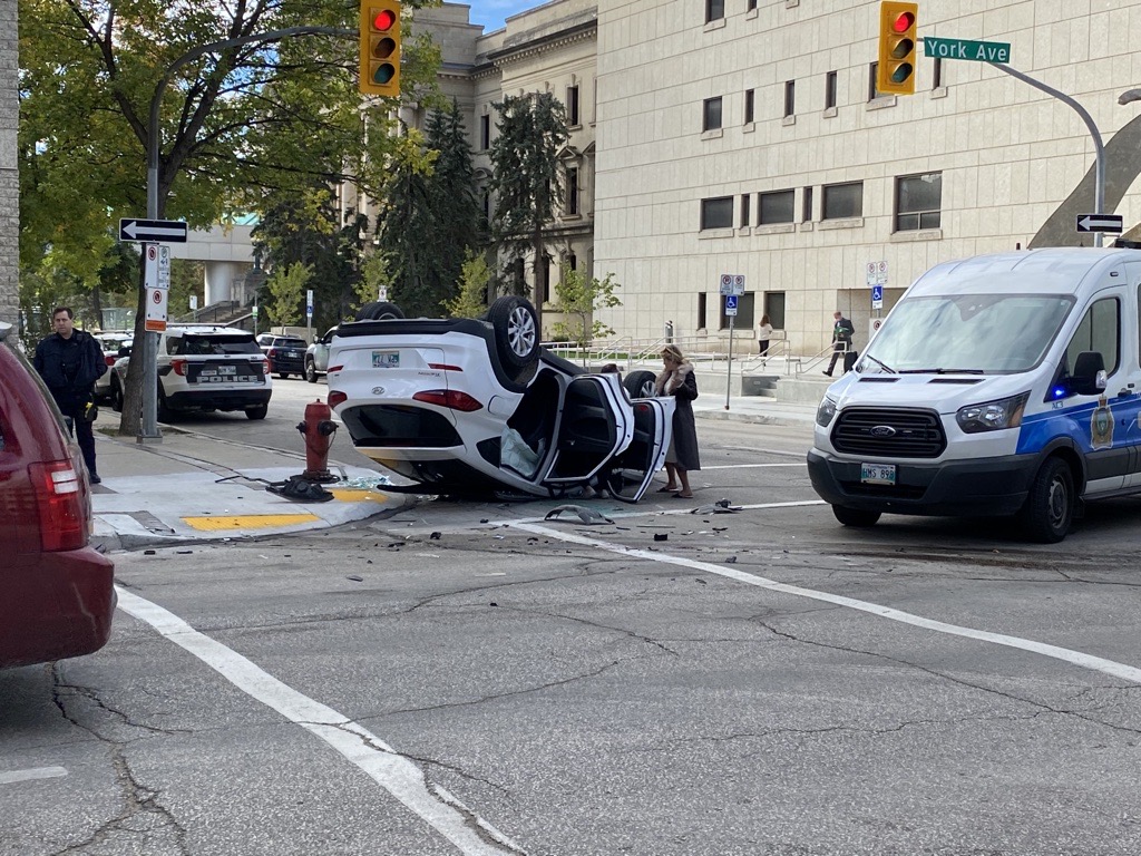 Emergency crews at the scene of a two-vehicle crash in downtown Winnipeg Friday.