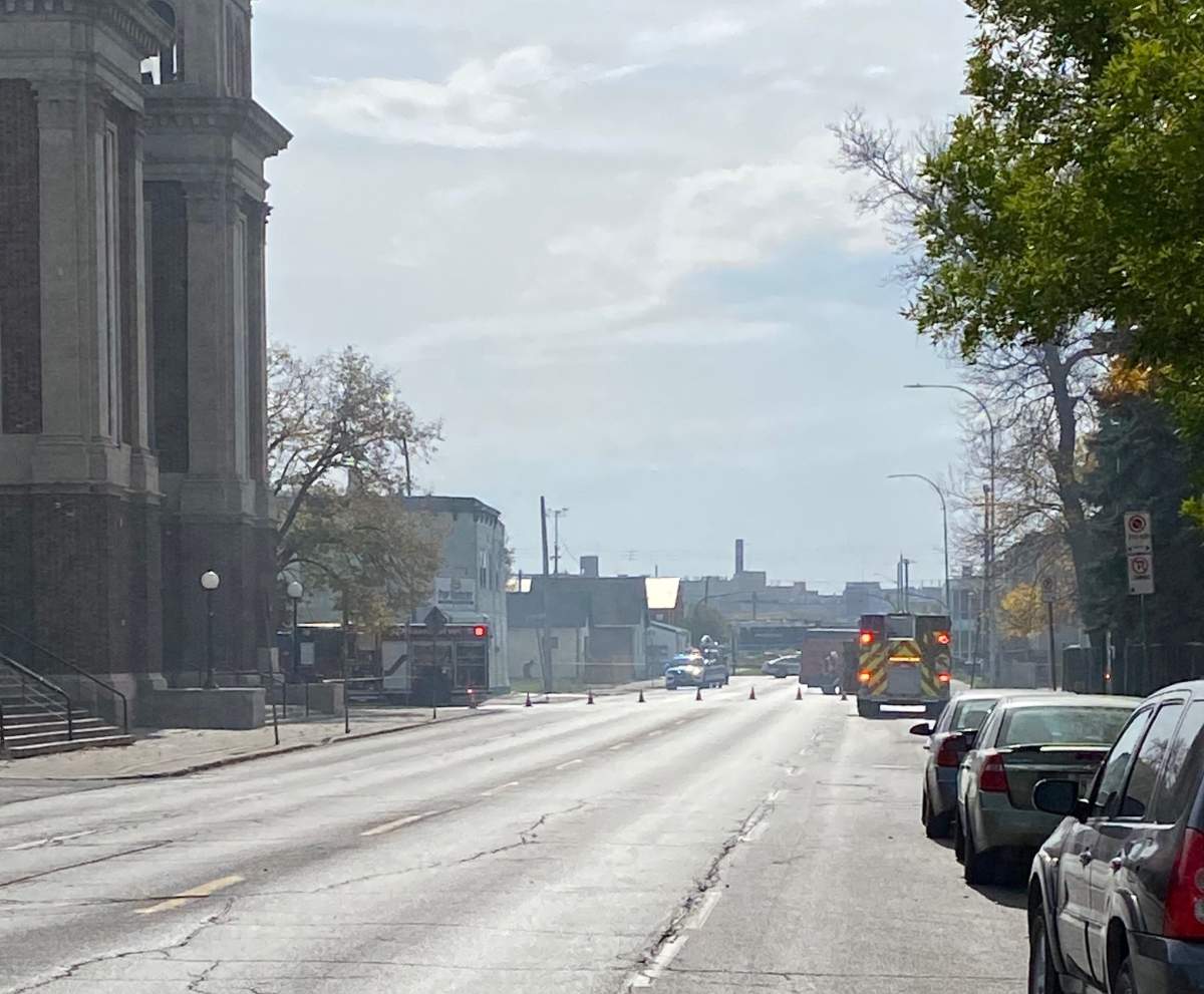 Winnipeg firefighters temporarily close a street while fighting a blaze Wednesday.