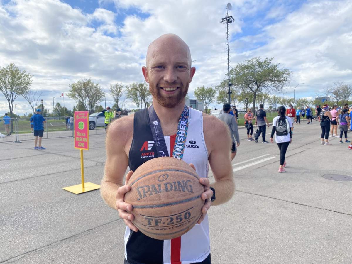 Steffan Reimer, 32, holds his now tattered basketball after dribbling it for the entirety of his full marathon.