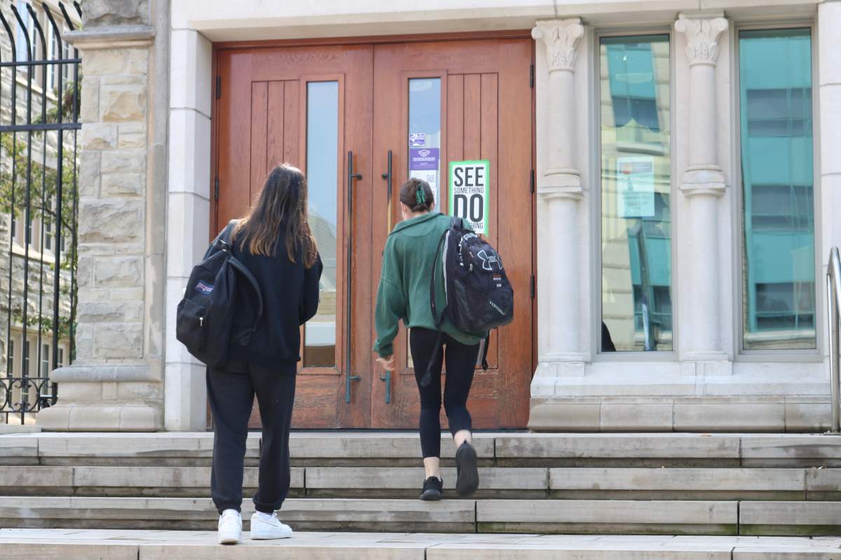 Two students walking into Sydenham Hall at Western University on Sept. 13, 2021.