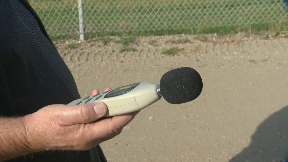 Glencairn resident Wayne Erhardt measures noise levels outside of his east Regina home.