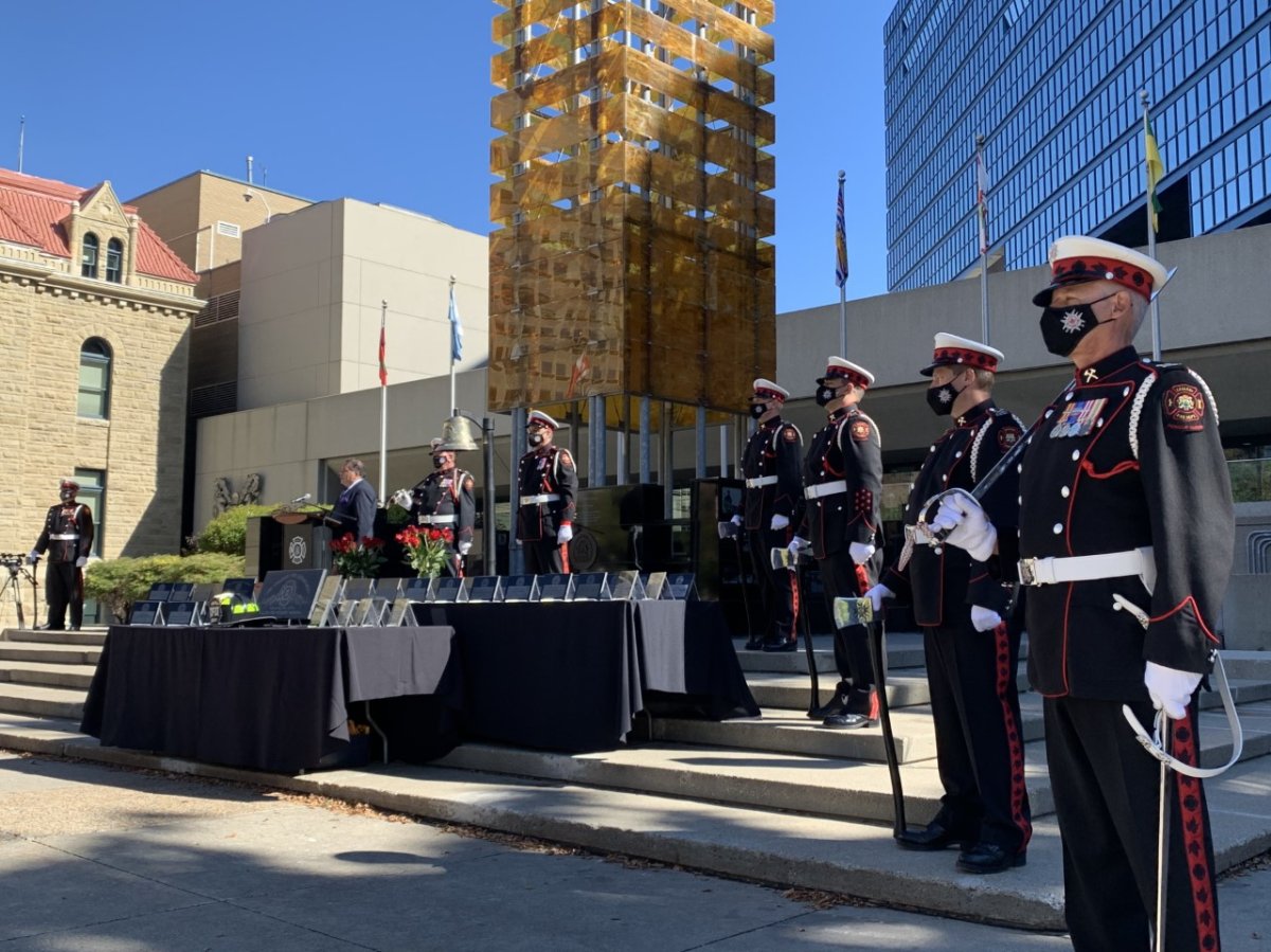 Calgary Mayor Naheed Nenshi is flanked by the firefighter honour guard on Sep. 14, 2021, during the city's annual firefighter memorial ceremony. Four names were added this year.