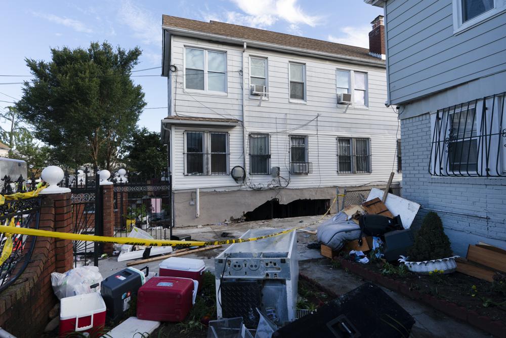 Damage to the side of a building from the remnants of Hurricane Ida is shown on Thursday, Sept. 2, 2021 in the Queens borough of New York. Three people were killed when several feet of water collapsed the wall to their basement apartment and flooded the apartment. (AP Photo/Mark Lennihan)