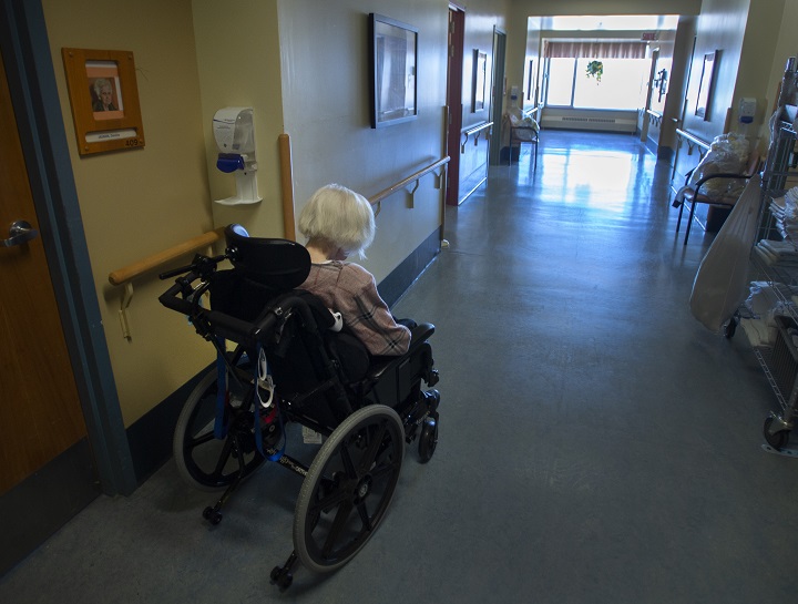 A resident makes her way down a hallway at CHSLD Rose-de-Lima seniors residence Friday, March 12, 2021 in Laval, Quebec. 