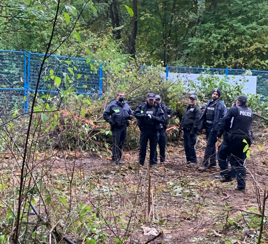 Burnaby RCMP enforce a court-ordered injunction at a Trans Mountain work site in Burnaby, B.C. on Tues. Sept. 28, 2021. Protesters have been occupying 'tree-sit' camps in the area for weeks in an effort to stop construction of the pipeline expansion.