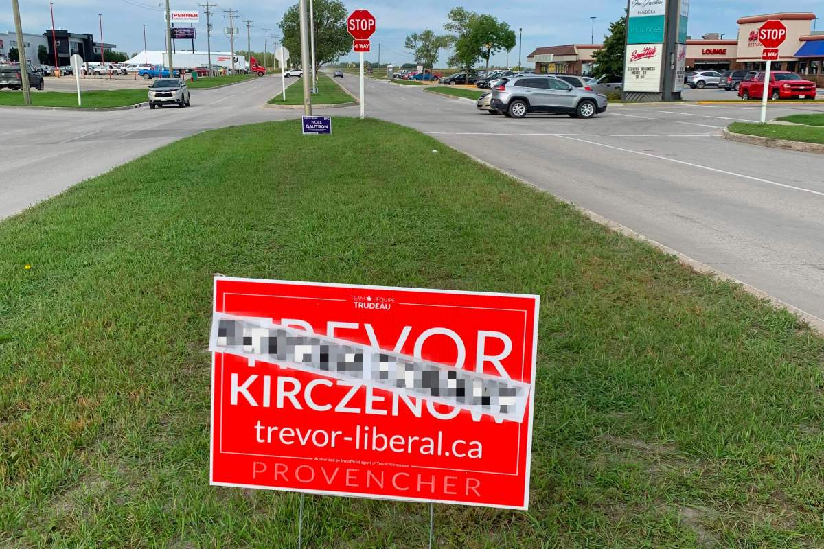 A blurred photo of Trevor Kirczenow's election signs featuring stickers with what he says are transphobic comments.