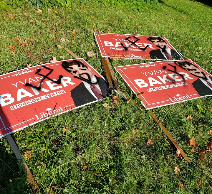 A photo of a defaced and vandalized Liberal Party candidate election sign for Etobicoke-Centre in Toronto. 