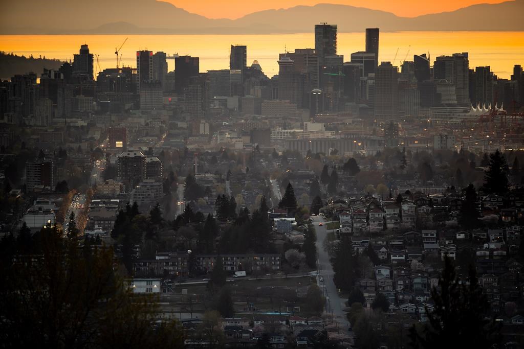 The downtown Vancouver skyline is seen at sunset, as houses line a hillside in Burnaby, B.C., on Saturday, April 17, 2021.